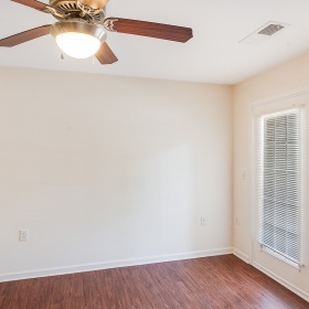 spacious room with a ceiling fan
