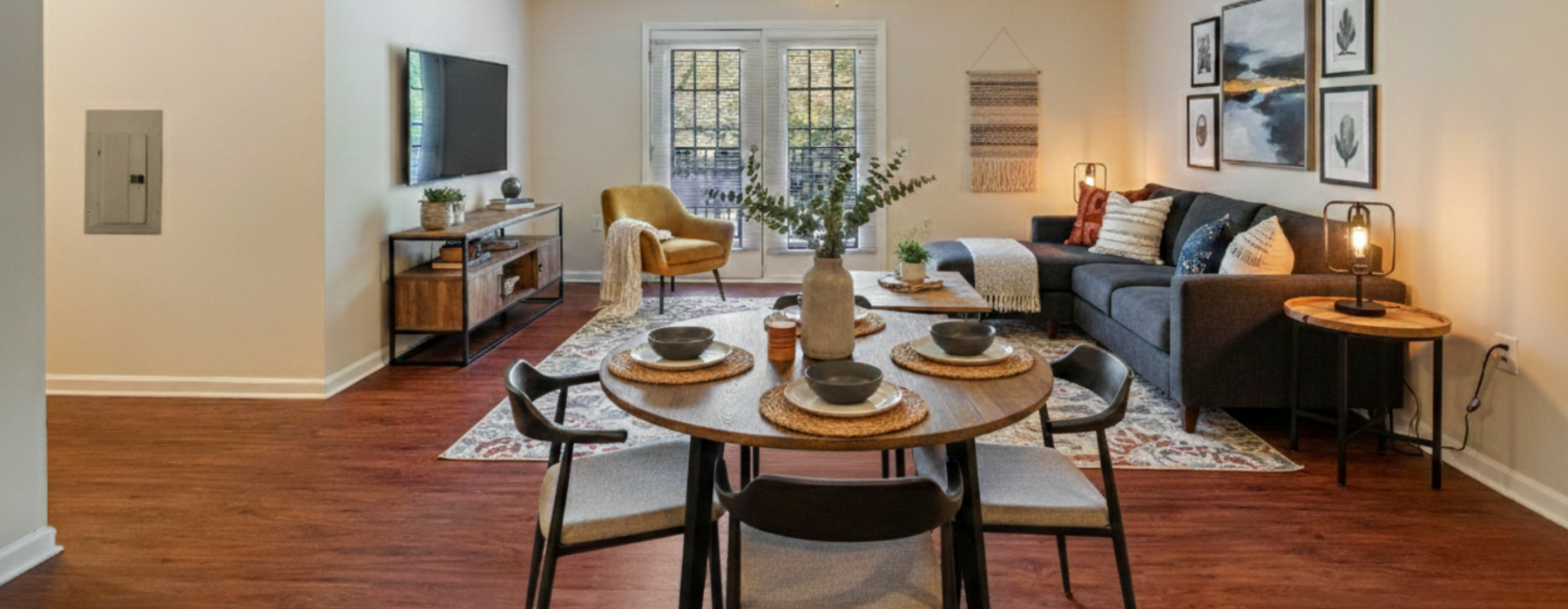Well lit living room with couch chair and TV and dining table