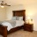 Large bedroom with natural lighting and ceiling fans